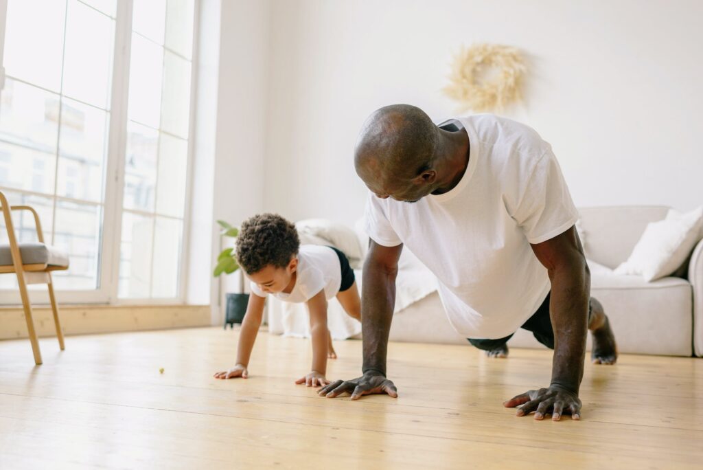 a father and son planking